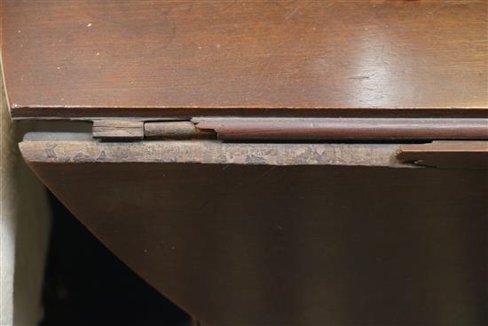 A George III mahogany double gateleg table opens to 2ft 4in. x 4ft 11in.